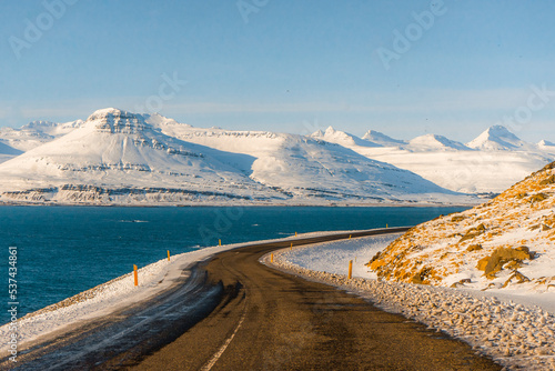 Along the way around Reydarfjordur , ports town close to the sea and snow mountain during winter sunny day at Reyðarfjörður , Fjord town on Eastern Coast of Iceland  : 19 March 2020 photo