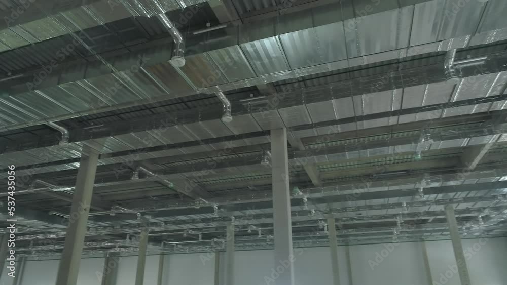 Ventilation ducts inside a large warehouse under construction. Aerial Ventilation ducts inside a large warehouse under construction. Aerial