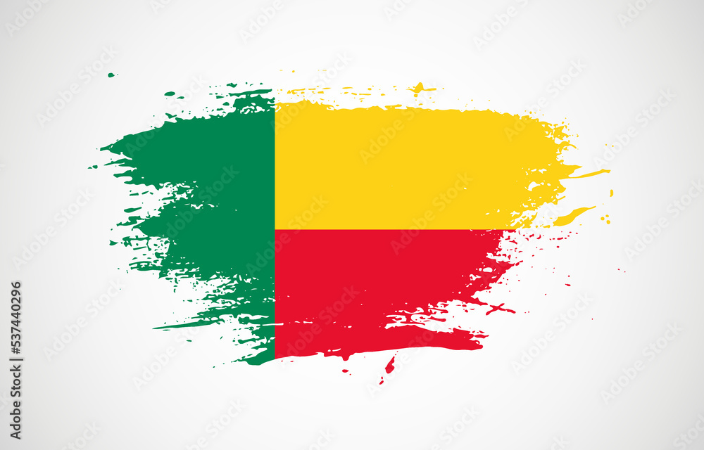 Obraz premium Grunge brush stroke with the national flag of Benin on a white isolated background