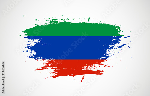Grunge brush stroke with the national flag of Dagestan on a white isolated background