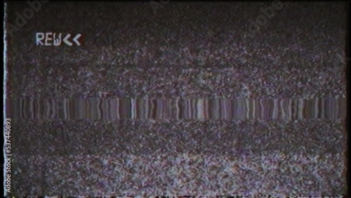 An overlay featuring a black and white VHS rewind effect and noise. photo