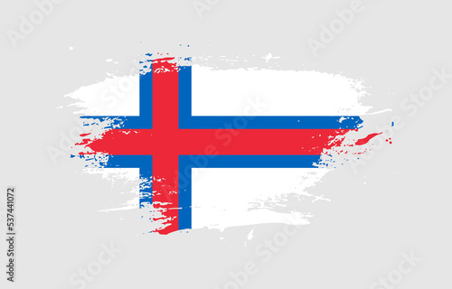 Grunge brush stroke with the national flag of Faroe Islands on a white isolated background
