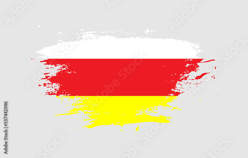 Grunge brush stroke with the national flag of North Ossetia on a white isolated background