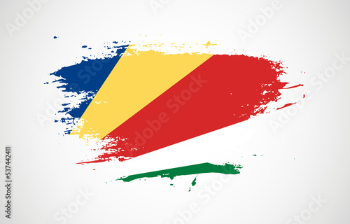 Grunge brush stroke with the national flag of Seychelles on a white isolated background