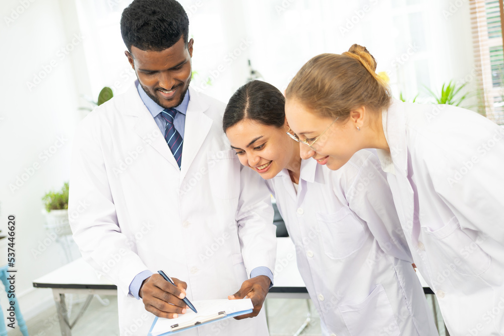 Scientists are taking notes. Happy teams of scientists experiment and research. international group of scientists. scientist teamwork. Scientists are taking notes. Happy teams of scientists experiment and research. international group of scientists. scientist teamwork.