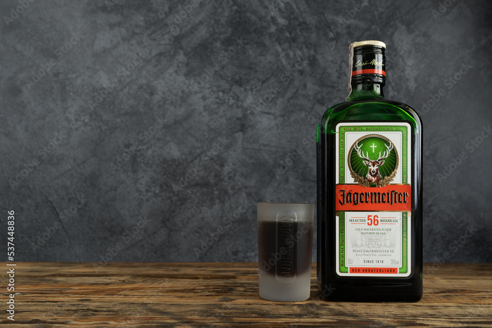 Jägermeister bottle and shot glass. German digestive alcohol drink