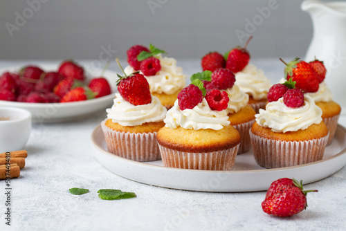 Cupcakes decorated with berries on the kitchen table