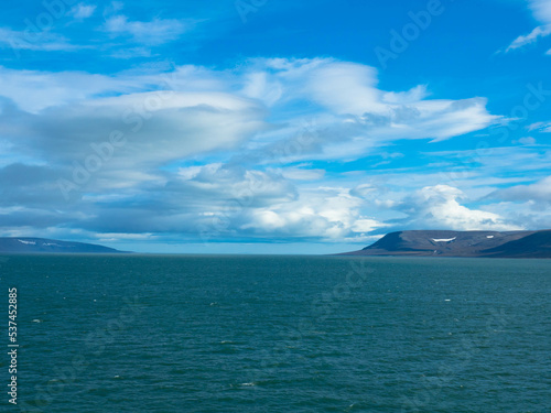 Spectacular panorama view of Wilhelmoya island with mountain range and blue sky. Torellneset, Nordaustlandet Spitsbergen, Norway. Tourism and vacations concept.