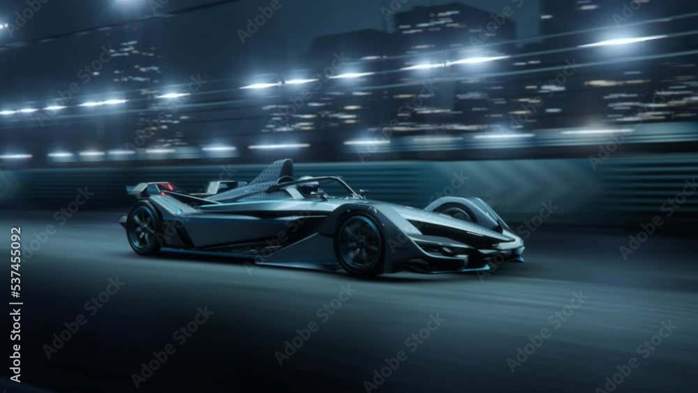 Fast Accelerating High Performance Electric Racing Car is Driving on Track at Night Time. Fast Accelerating High Performance Electric Racing Car is Driving on Track at Night Time.
