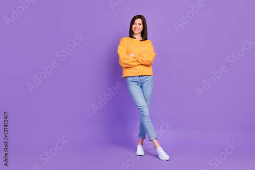 Full length photo of cute satisfied nice looking lady wear autumn sweatshirt stand empty space isolated on purple color background