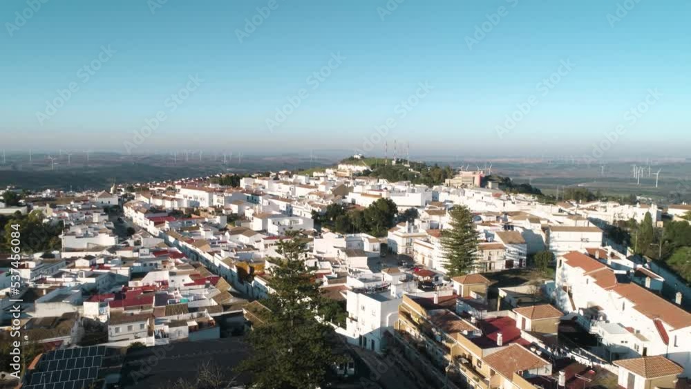 Aerial ascending dolly shot of the idyllic old town medina sidonia in andalucia spain with white buildings and a wide view of the landscape with blue sky on a sunny day. Cadiz Aerial ascending dolly shot of the idyllic old town medina sidonia in andalucia spain with white buildings and a wide view of the landscape with blue sky on a sunny day. Cadiz
