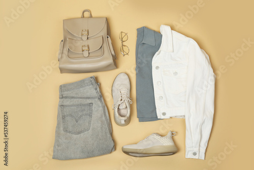 Set of stylish clothes and accessories on beige background, flat lay