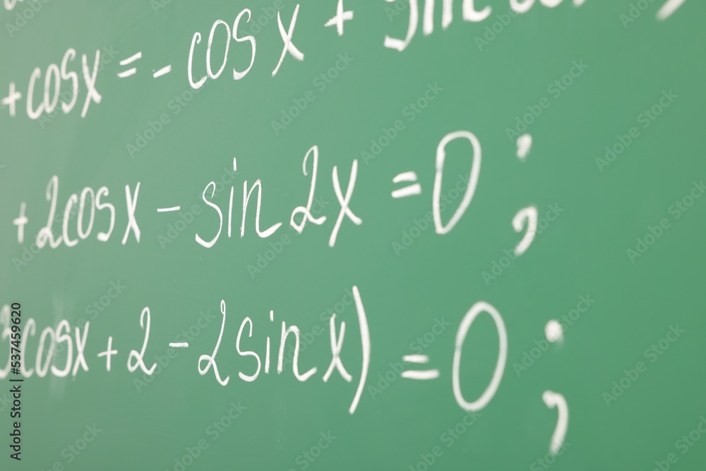 Many different math formulas written on green chalkboard, closeup Many different math formulas written on green chalkboard, closeup