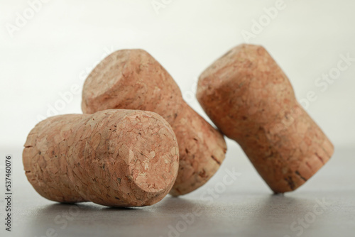 Corks of wine bottles on light grey table, closeup