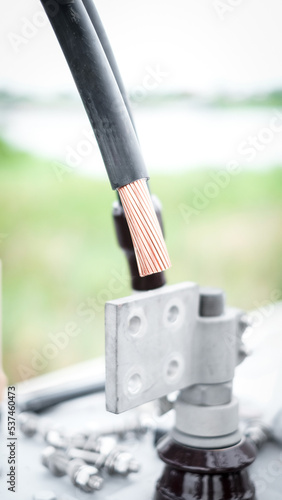 Large copper power cable in section.High voltage power transformer with electrical insulation and electrical equipment in power substation.