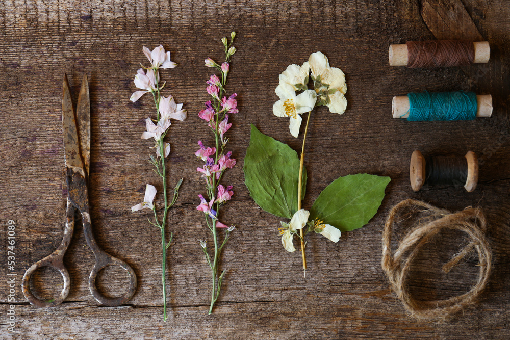 Flat lay composition with beautiful dried flowers on wooden table Flat lay composition with beautiful dried flowers on wooden table