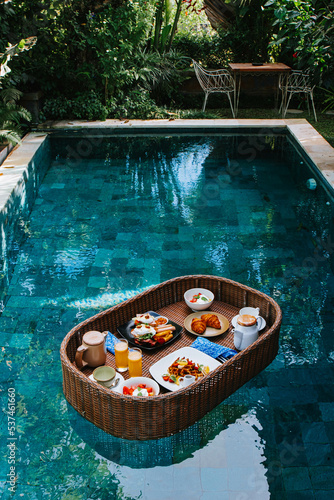 Breakfast tray is floating on the swimming pool © David