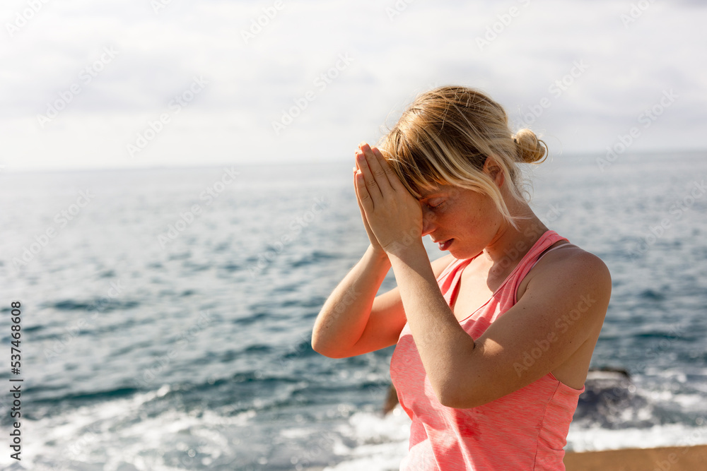 Beautiful young woman practising yoga outside. Fit woman doing stretching exercises at the beach... Beautiful young woman practising yoga outside. Fit woman doing stretching exercises at the beach...