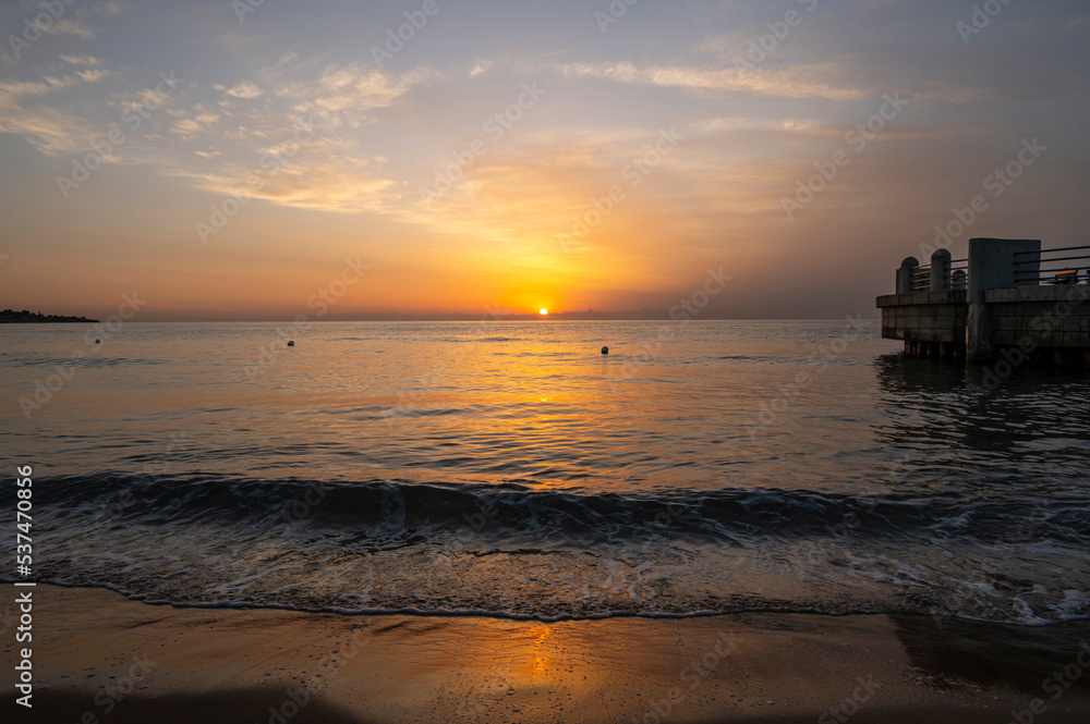A wonderful sunrise with beautiful colors on the sea seen from the beach of the roundabout on the sea of Avola