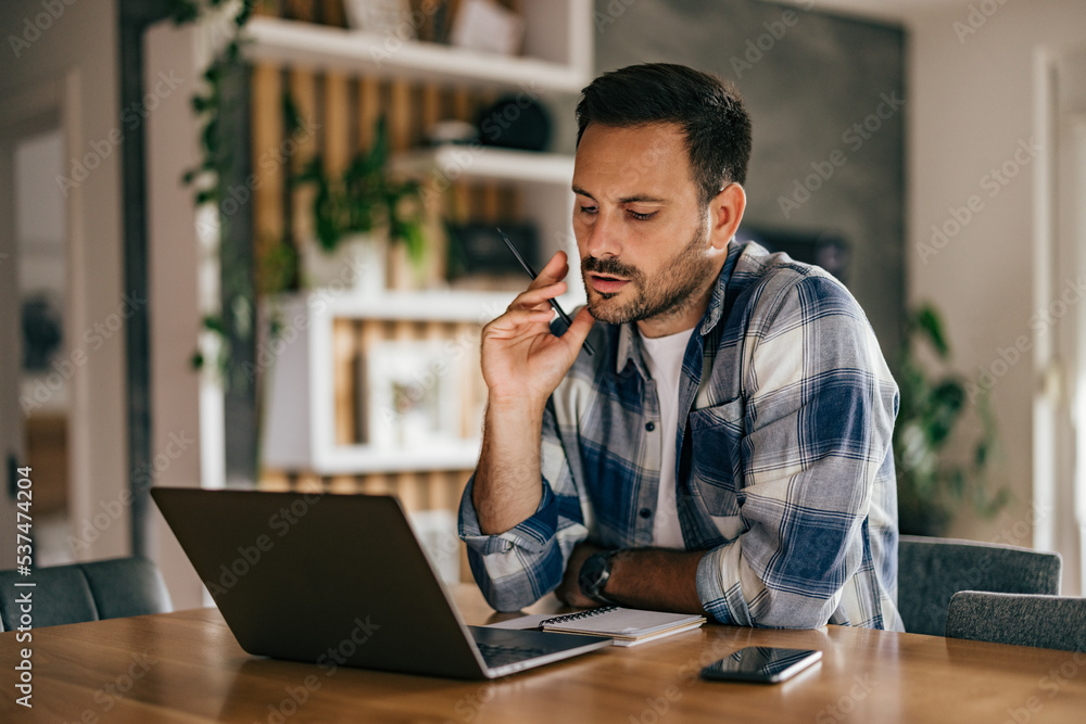 Businessman working from home office, using a laptop. Businessman working from home office, using a laptop.