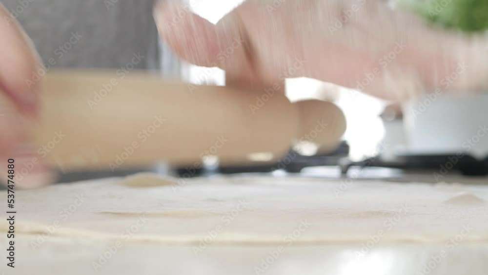 Senior Bakery Chef Rolling Dough on the Kitchen Table. Man in the Kitchen Making Dough for Traditional Homemade Pizza and Pastry. Senior Bakery Chef Rolling Dough on the Kitchen Table. Man in the Kitchen Making Dough for Traditional Homemade Pizza and Pastry.