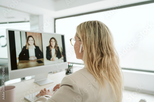 Businesswoman having a video call at desk in office photo