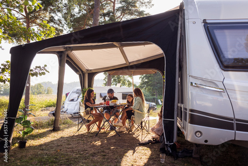 Family relaxing at camping site photo