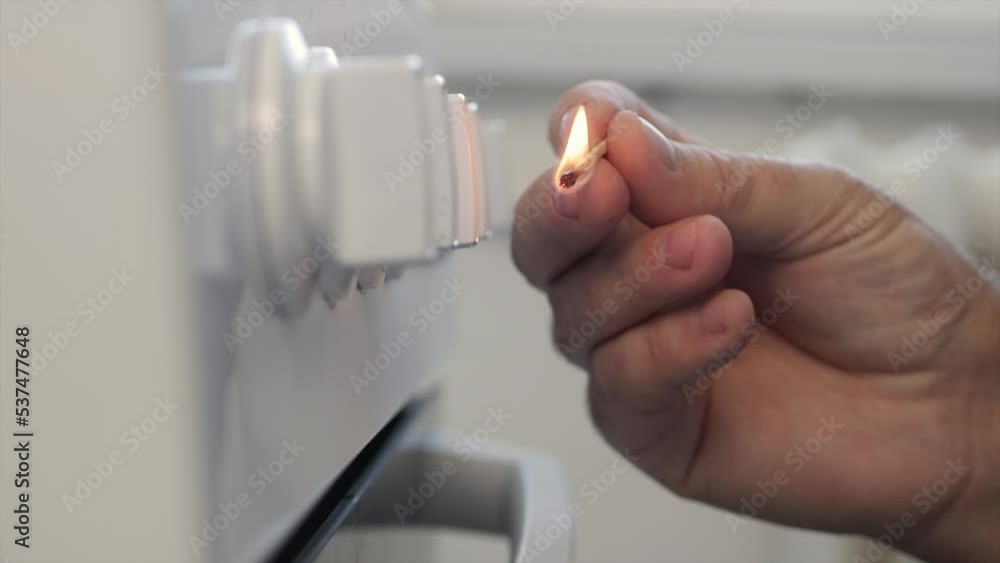 A Man Lighting Up Fire at Gas Cooker Using Matches. CloseUp Shooting