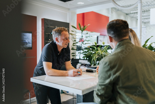 Salesman talking with customers