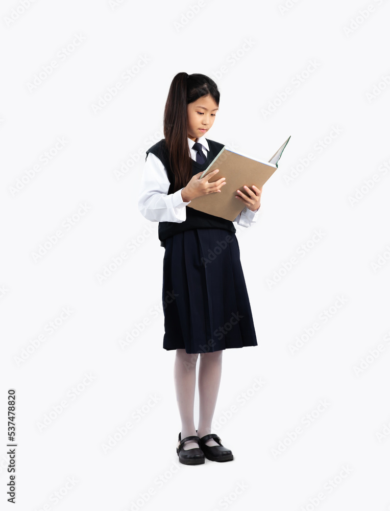 Asian girl in student school uniform standing and reading book on white background full length isolated. Asian girl in student school uniform standing and reading book on white background full length isolated.