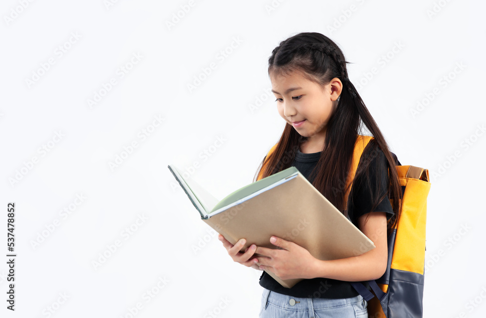 Elementary school kid in private uniform standing and reading book on white background. Back to school. Elementary school kid in private uniform standing and reading book on white background. Back to school.