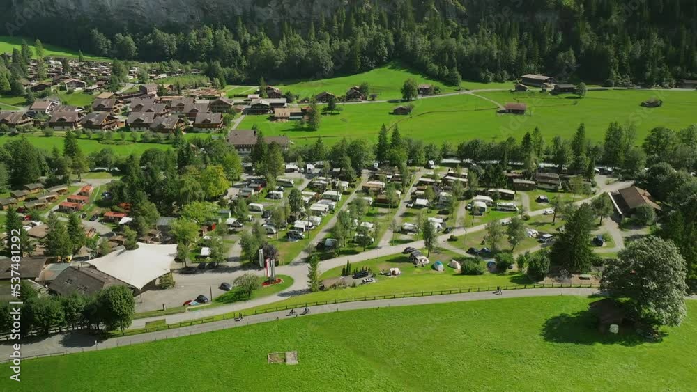 Aerial views of cyclist riding by camping Jungfrau in Lauterbrunnen, Switzerland Aerial views of cyclist riding by camping Jungfrau in Lauterbrunnen, Switzerland