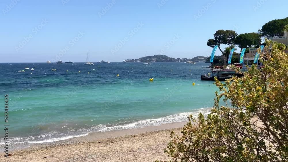 Waves Crashing On The Shoreline Of Plage des Fourmis At Summer In Beaulieu-sur-Mer, France. - wide Waves Crashing On The Shoreline Of Plage des Fourmis At Summer In Beaulieu-sur-Mer, France. - wide