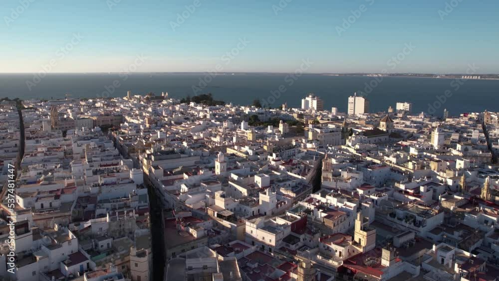 Aerial View of Cadiz, Spain, Cityscape on Sunny Evening and Pacific Ocean in Skyline, Rising Drone Shot