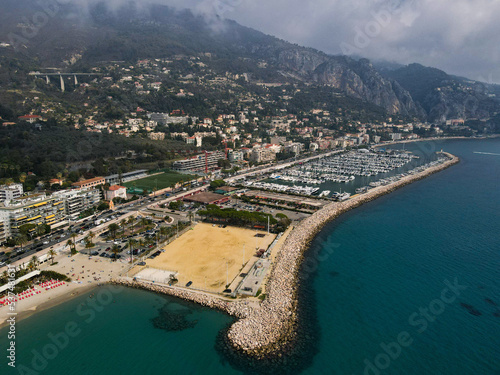 Aerial view of Menton in French Riviera from above. Drone view of France Cote d'Azur sand beach beneath the colorful old town of Menton. Small color houses near the border with Italy, Europe. © AerialDronePics
