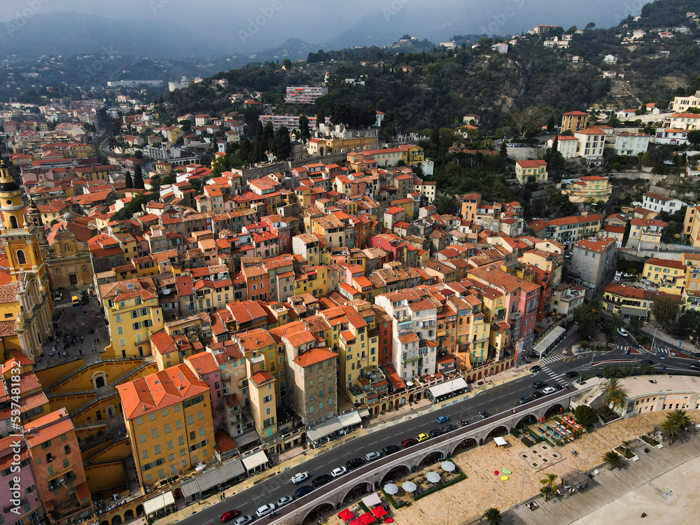 Obraz premium Aerial view of Menton in French Riviera from above. Drone view of France Cote d'Azur sand beach beneath the colorful old town of Menton. Small color houses near the border with Italy, Europe.