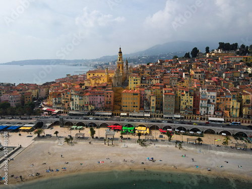 Aerial view of Menton in French Riviera from above. Drone view of France Cote d'Azur sand beach beneath the colorful old town of Menton. Small color houses near the border with Italy, Europe.