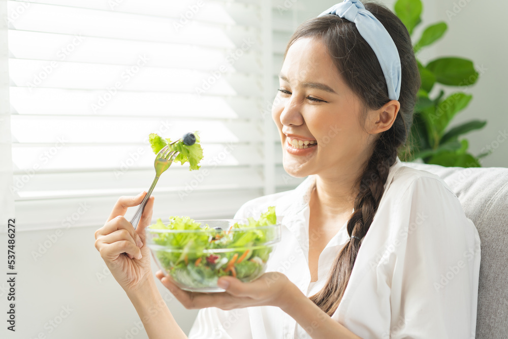 Diet, Dieting pretty attractive asian young woman, girl use fork at lettuce on mix vegetables, green salad bowl, eat food is low fat to good body. Nutritionist female, Weight loss for healthy person. Diet, Dieting pretty attractive asian young woman, girl use fork at lettuce on mix vegetables, green salad bowl, eat food is low fat to good body. Nutritionist female, Weight loss for healthy person.