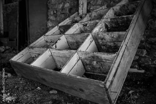 Monochrome shot of an old broken cupboard in an abandoned house