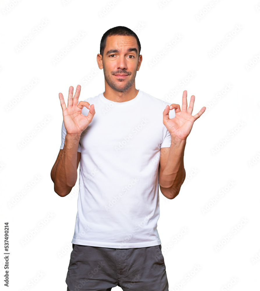 Worried young man doubting and making a gesture of approval Worried young man doubting and making a gesture of approval