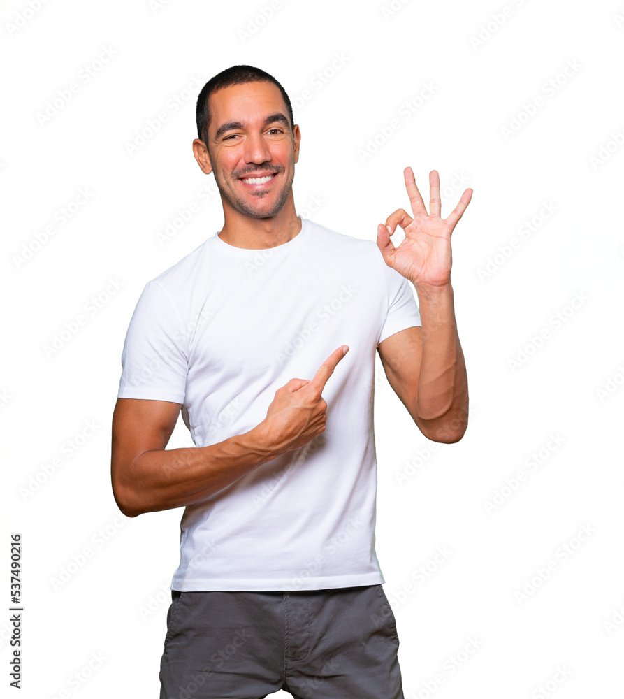 Surprised young man with a gesture of approval Surprised young man with a gesture of approval