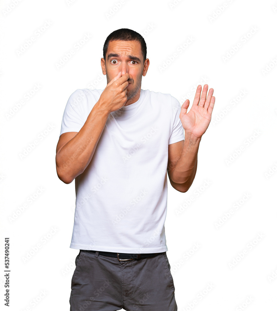 Concerned young man with a gesture of disgust Concerned young man with a gesture of disgust