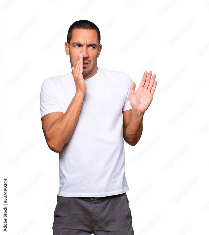 Concerned young man with a gesture of disgust Concerned young man with a gesture of disgust