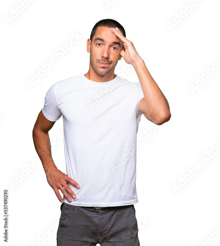 Tired young man posing against background