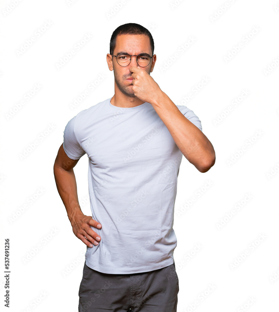 Concerned young man with a gesture of disgust Concerned young man with a gesture of disgust