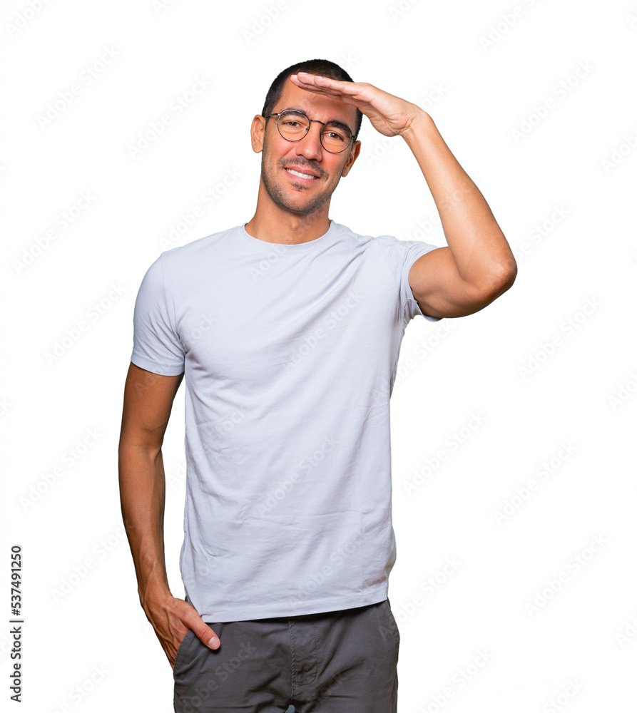 Happy young man with a gesture of looking away Happy young man with a gesture of looking away