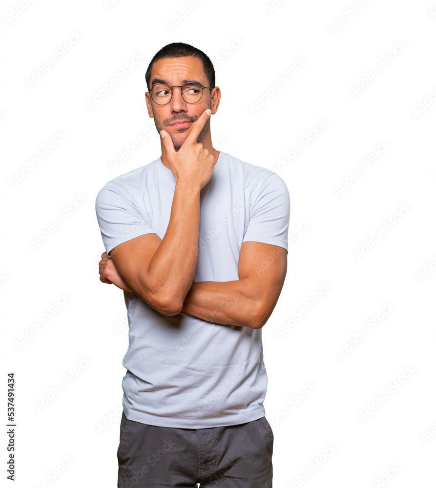 Concerned young man making a gesture of doubt Concerned young man making a gesture of doubt