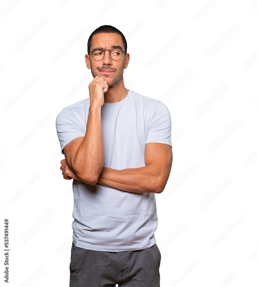 Angry young man posing against background Angry young man posing against background