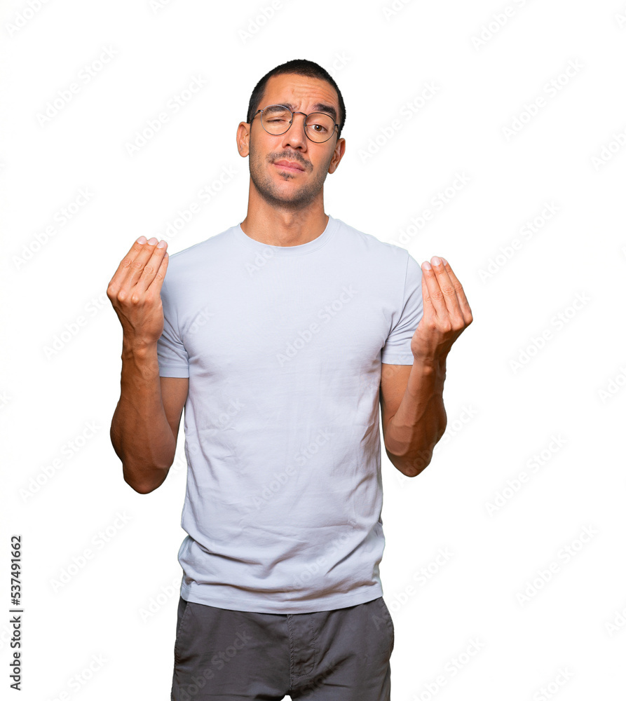 Confused young man making an italian gesture of not understand Confused young man making an italian gesture of not understand