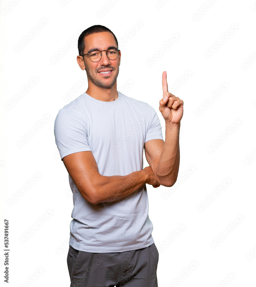 Fototapeta premium Young man making a number one gesture
